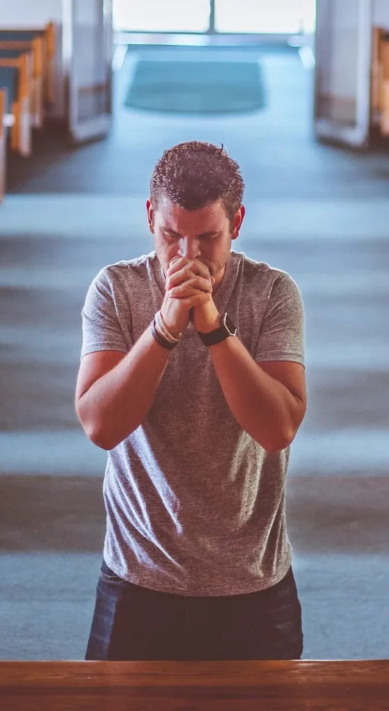 Pastor praying in a church alone